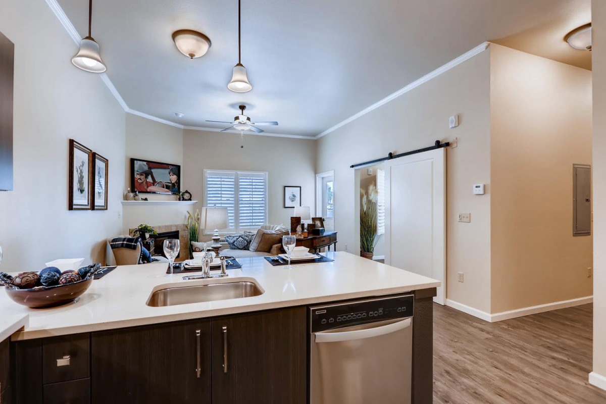 A modern open-concept kitchen and living room with contemporary furnishings.