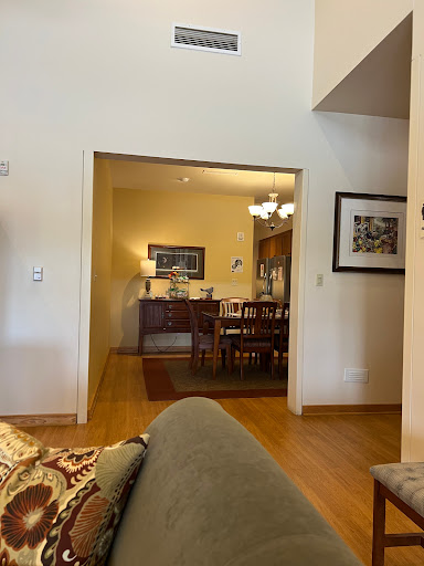 A welcoming view from the living room into the dining area, showcasing a cozy home atmosphere.