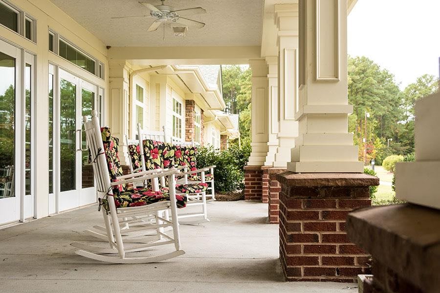 A cozy porch with rocking chairs and classic architecture.