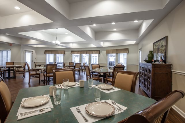 A well-arranged dining room with tables set for a meal.