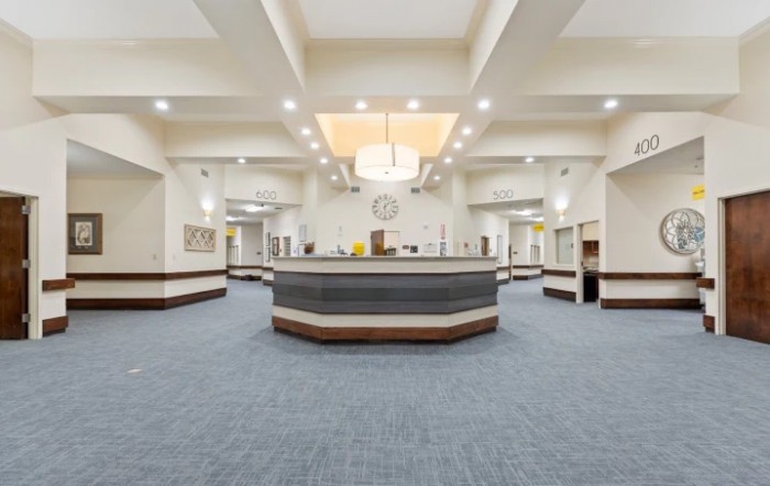 A modern reception area with a central counter and elegant lighting.