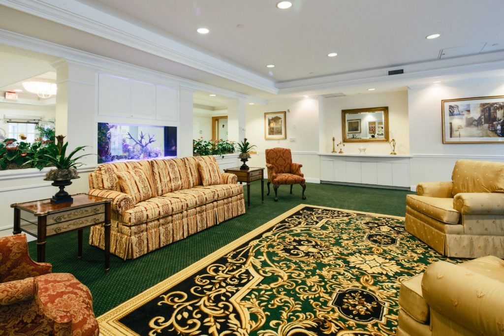 A cozy living room with ornate carpeting and comfortable seating.
