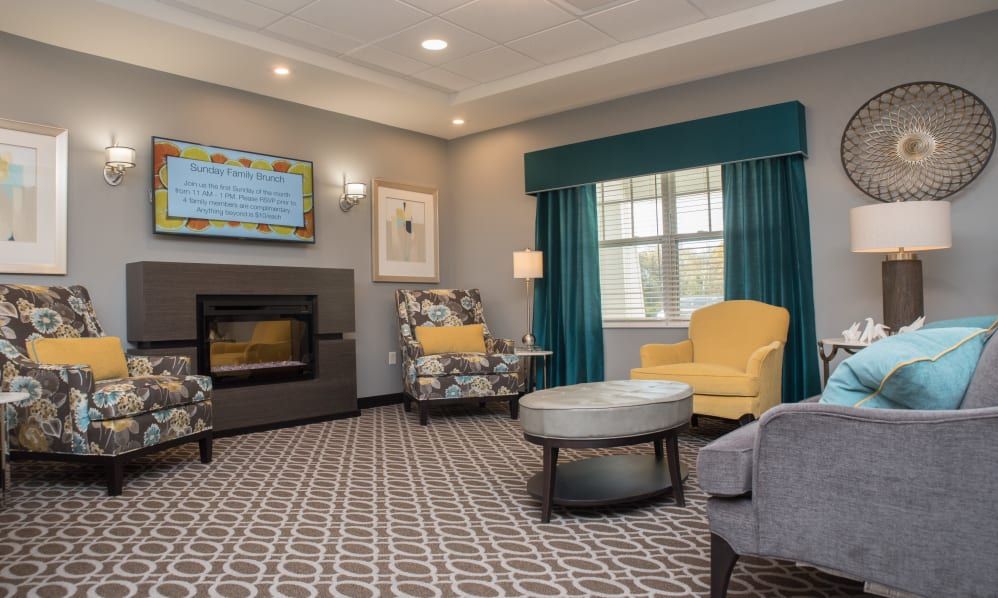 A modern living room with comfortable seating, a fireplace, and elegant decor.