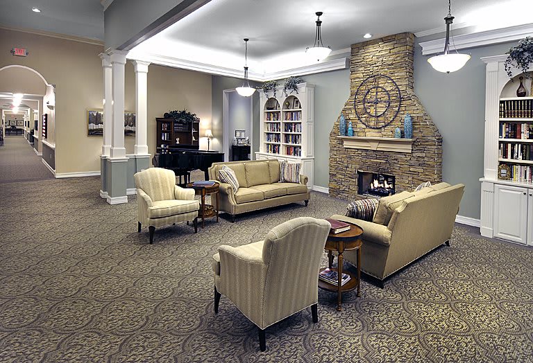 A cozy living room with comfortable seating, a fireplace, and elegant decor.