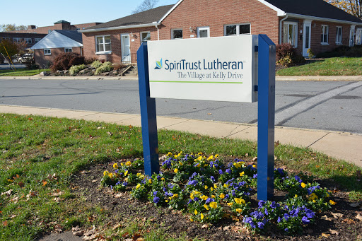 Sign for Spiritual Lutheran, the College of Adult Studies, prominently displayed outside.