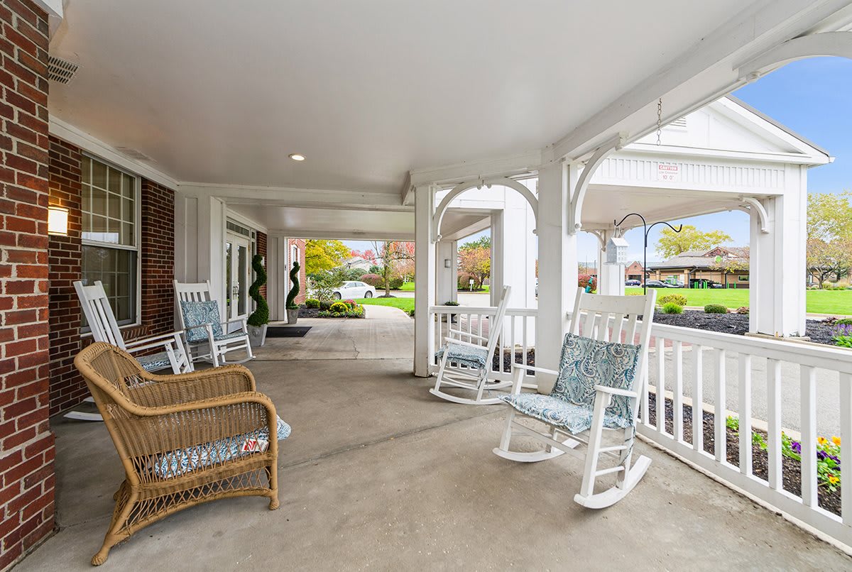 A cozy porch with rocking chairs and wicker seating, perfect for relaxation.