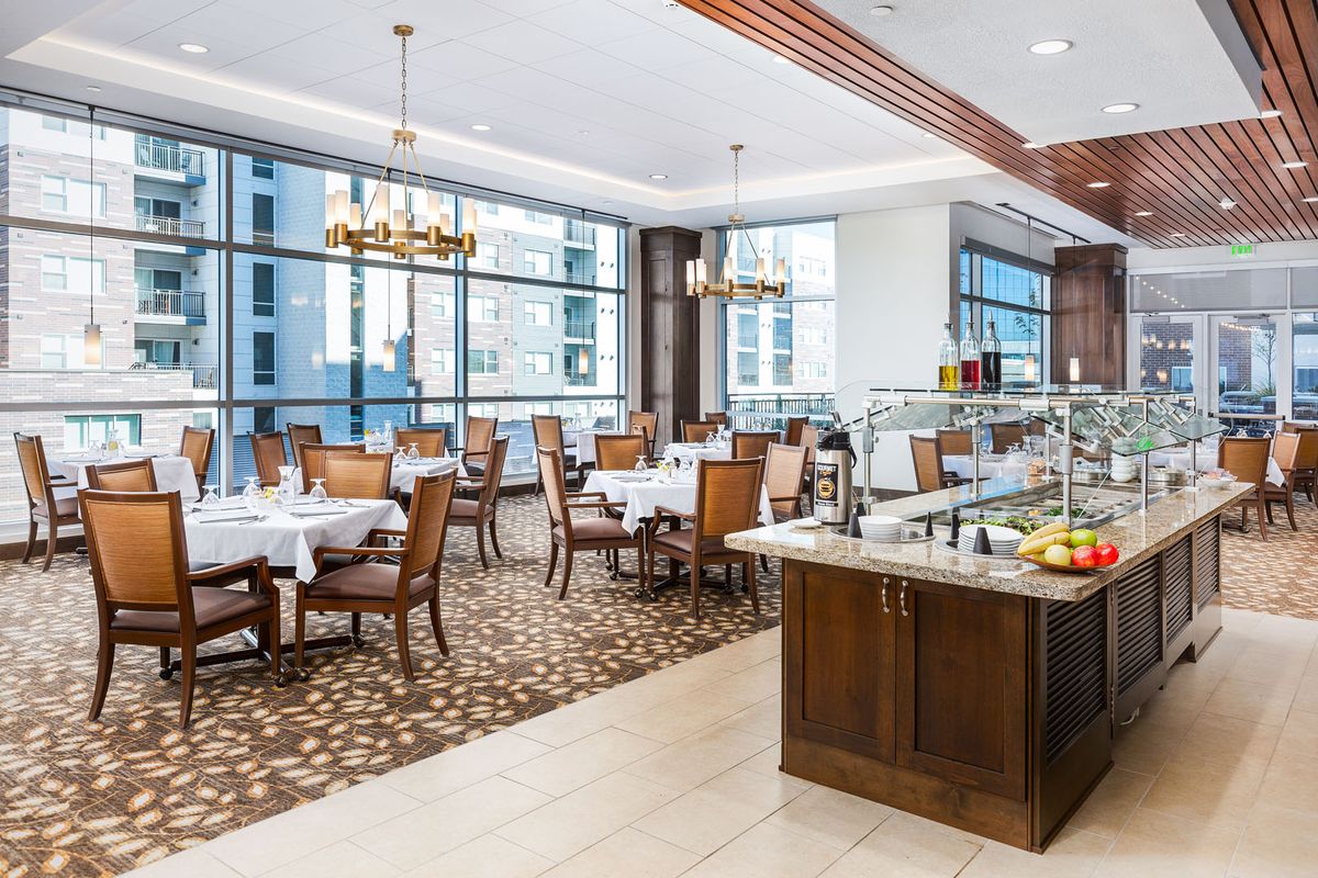 Elegant dining area with large windows and a buffet setup.