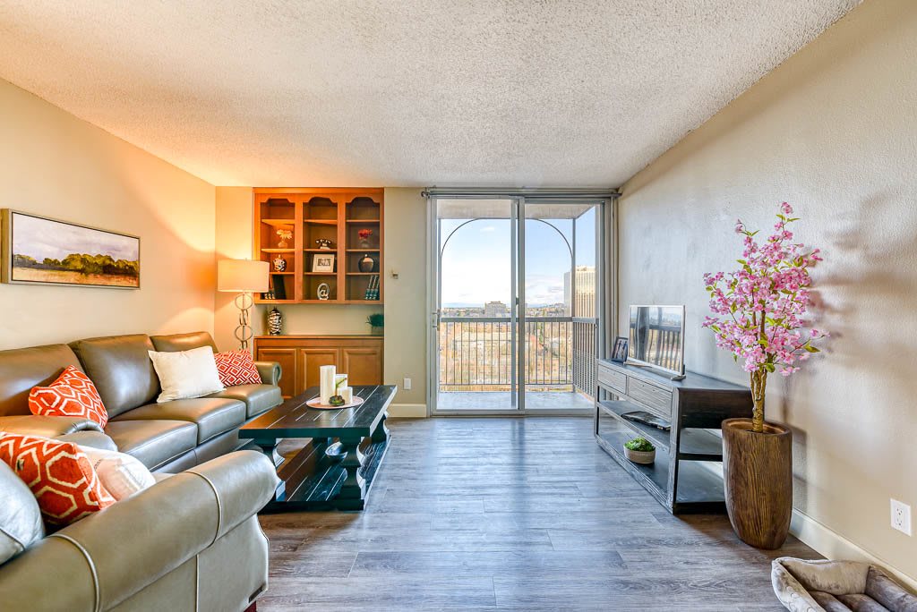 A modern living room with a comfortable sofa, coffee table, and entertainment unit.