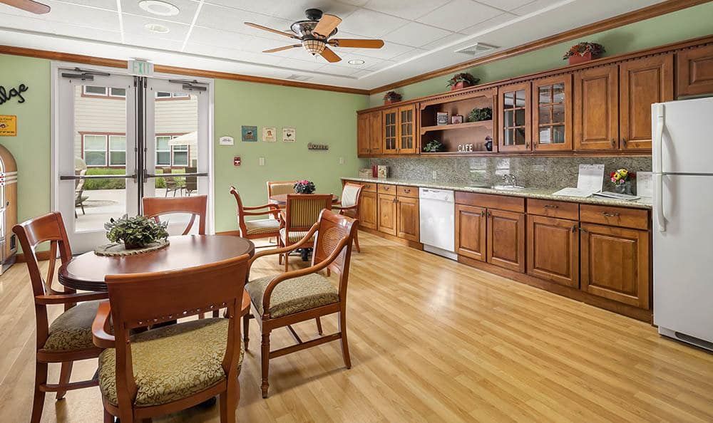 A cozy kitchen and dining area with wooden cabinets and a hardwood floor.
