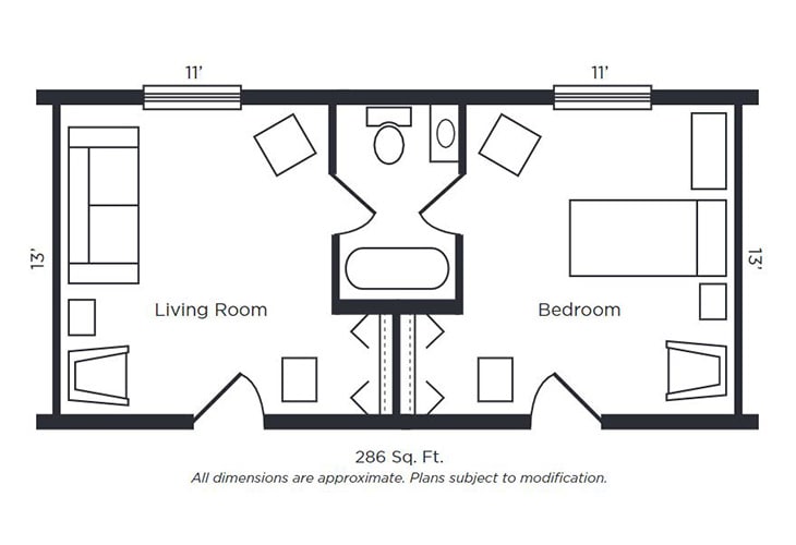 A compact floor plan of an apartment featuring a living room, a bedroom, and a bathroom in the center, covering 285 sq. ft.