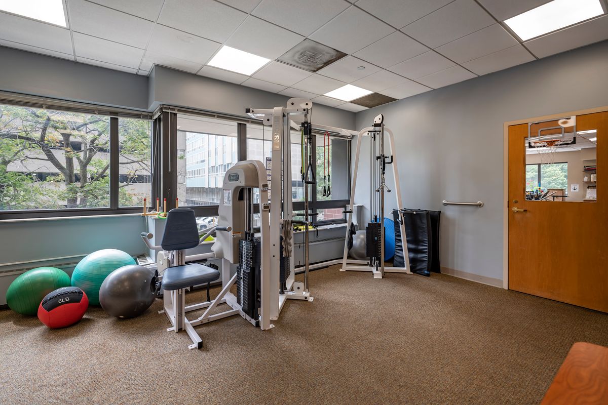 An indoor gym equipped with fitness machines and exercise equipment.