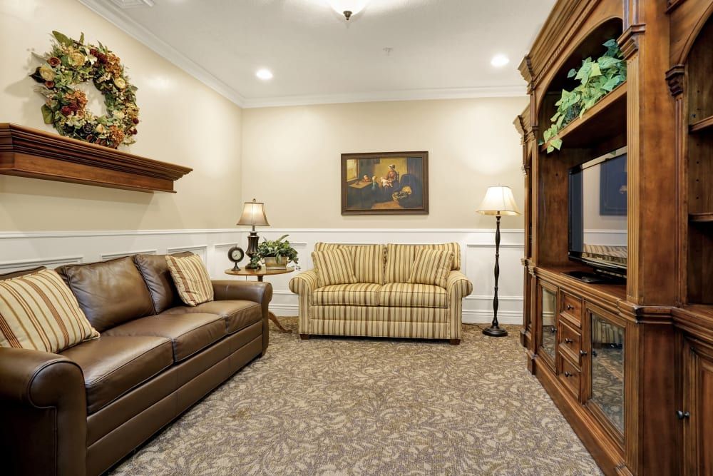 A cozy living room with comfortable seating and a classic entertainment center.