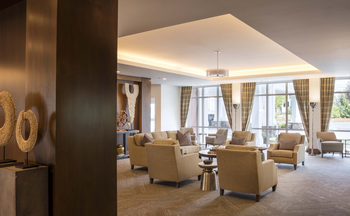A comfortable and modern lobby seating area with plush chairs and large windows.