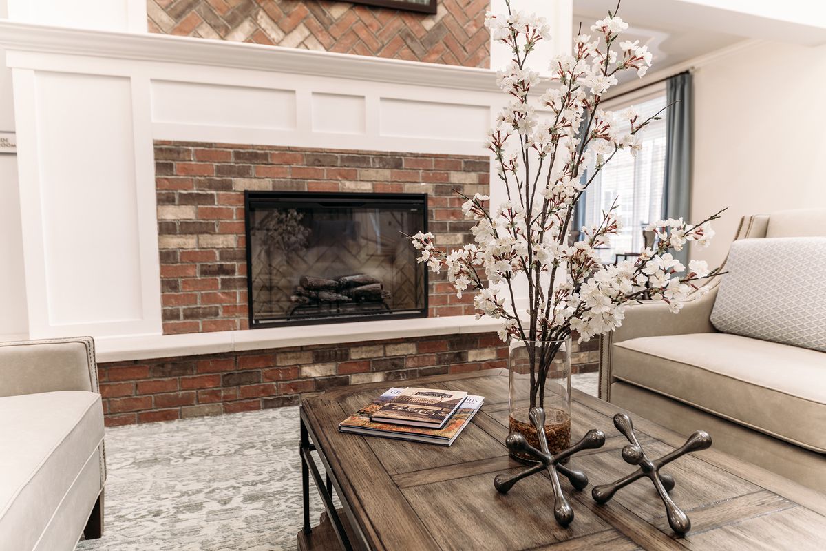 Cozy living room with a brick fireplace and elegant decor.