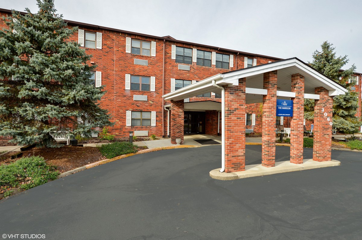A brick hotel building with an entrance and driveway.