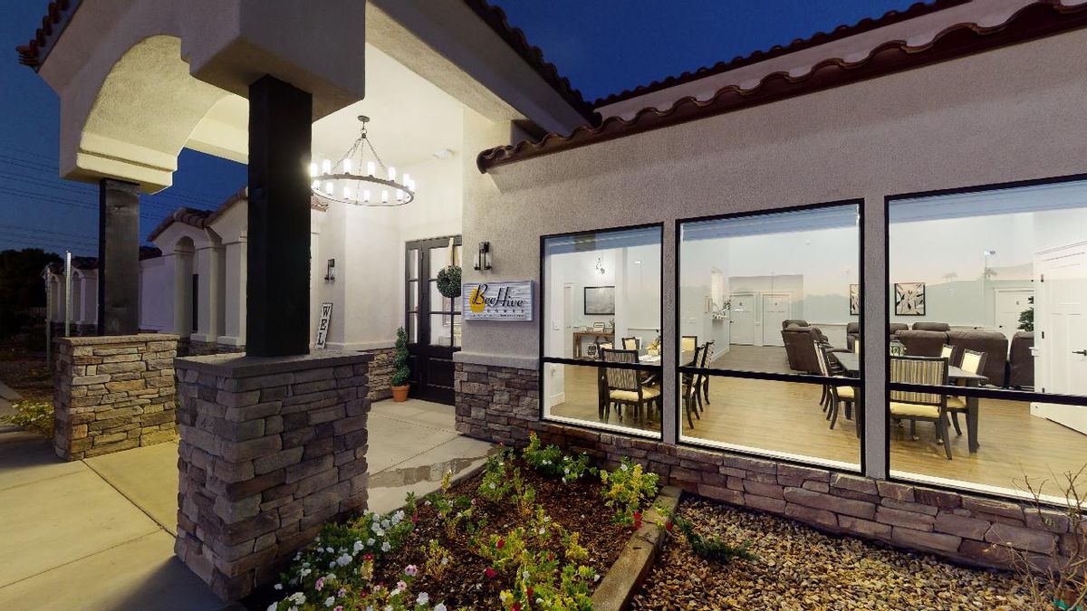 Exterior view of a house at night, showcasing modern architecture and illuminated interior.