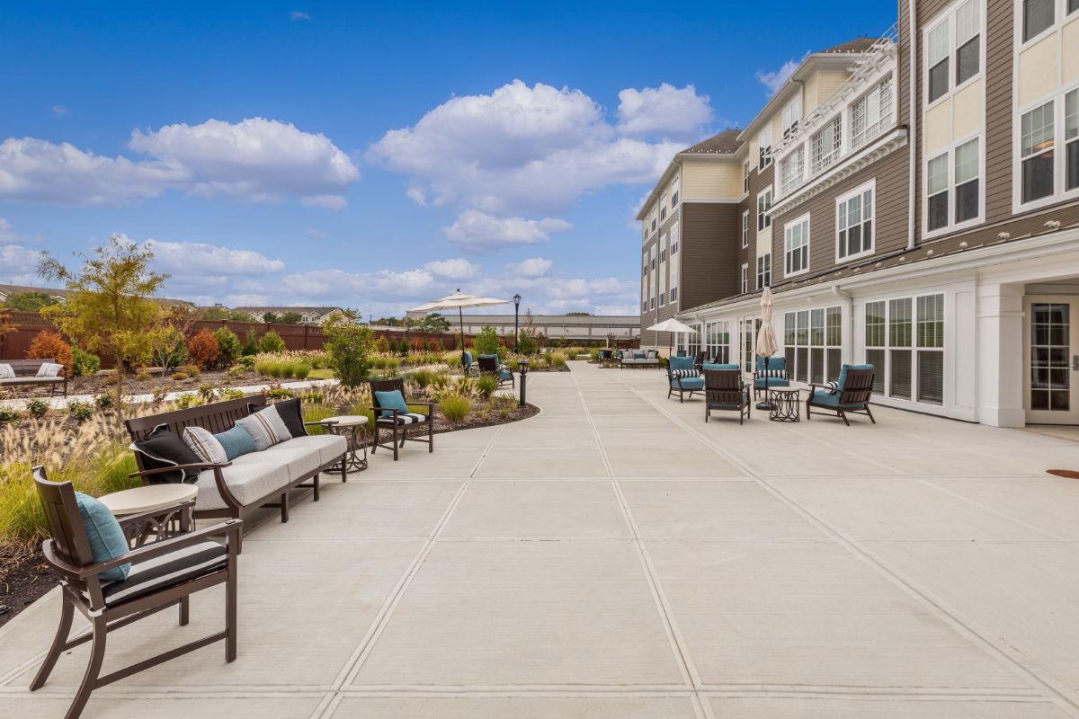A spacious outdoor patio area with seating and a view of the surrounding landscape.