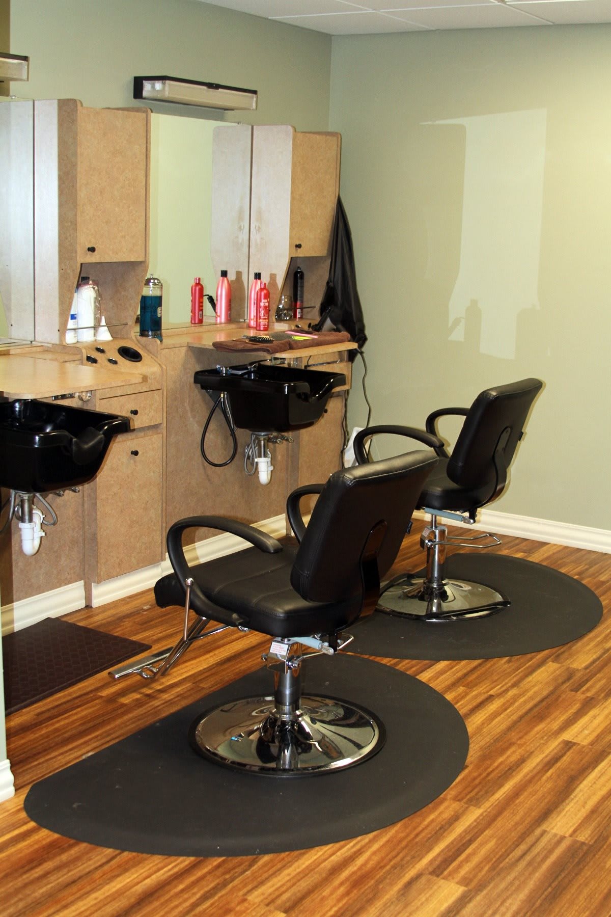 A tidy and inviting hair salon with styling stations and mirrors.