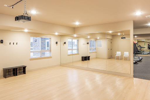 A spacious and bright dance studio with mirrors for practice.