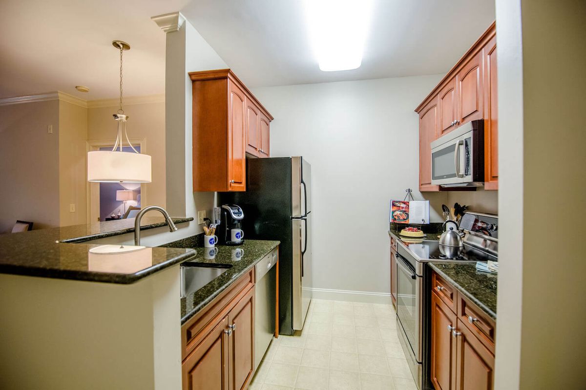 A modern kitchen with stainless steel appliances and wooden cabinets.