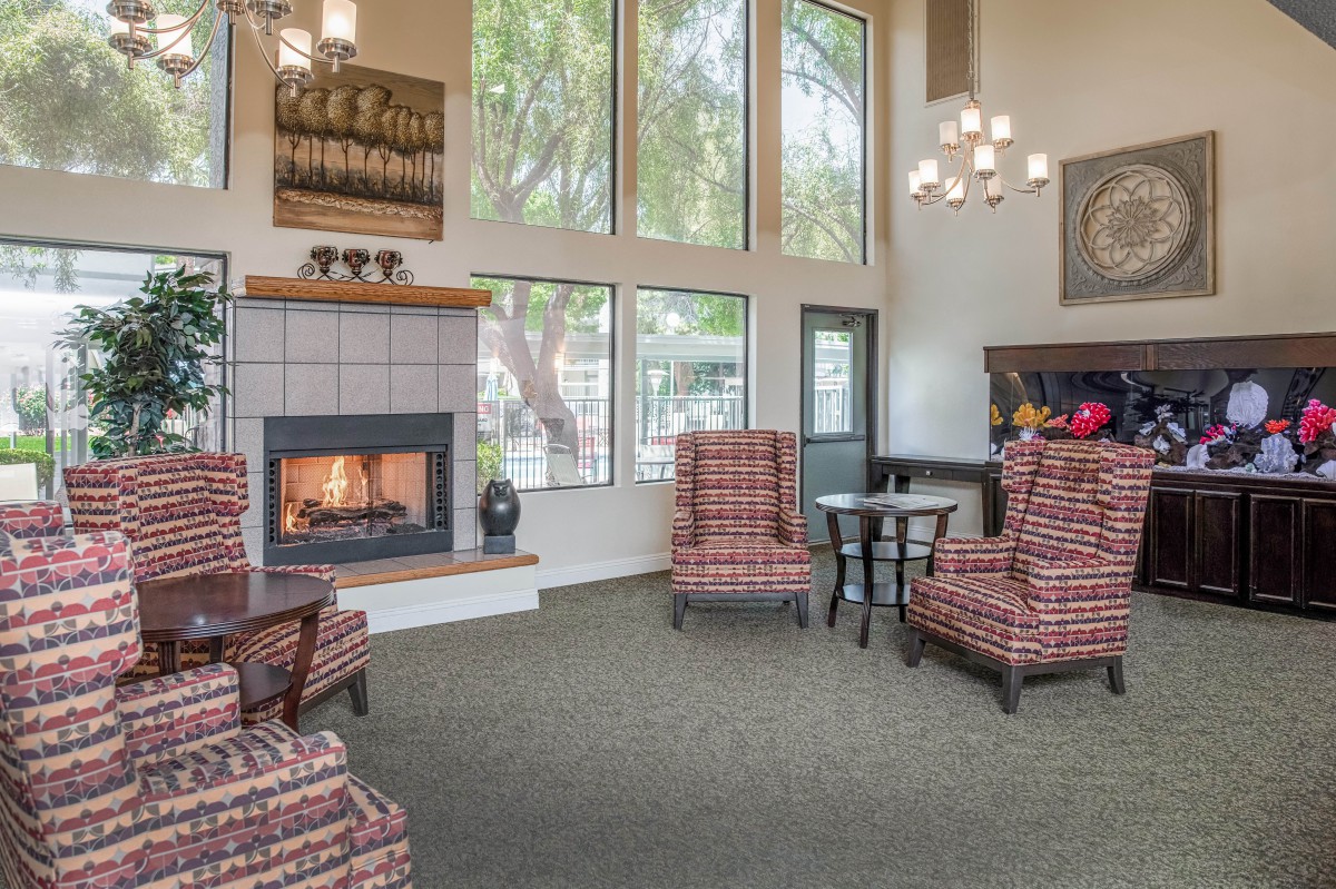 A cozy living room with a fireplace and comfortable seating.