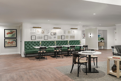 A modern dining area featuring elegant green seating and stylish decor.