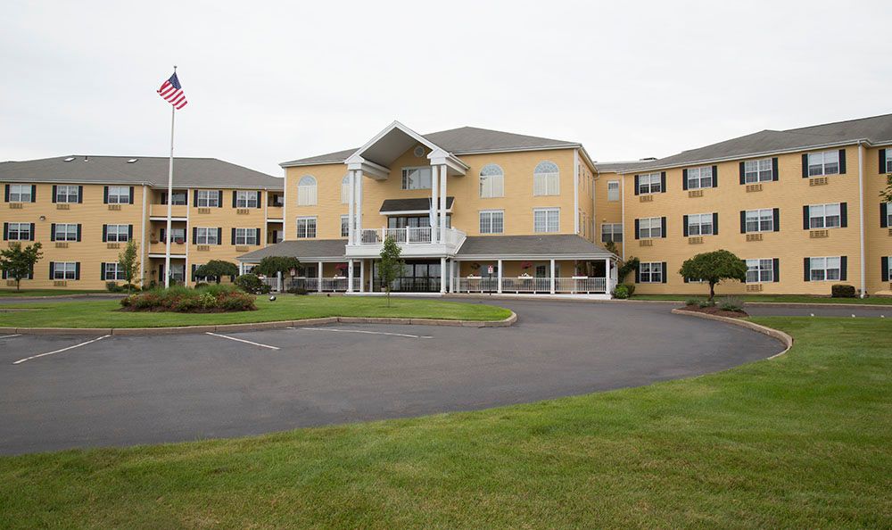 A large residential building with a well-maintained exterior and landscaped surroundings.