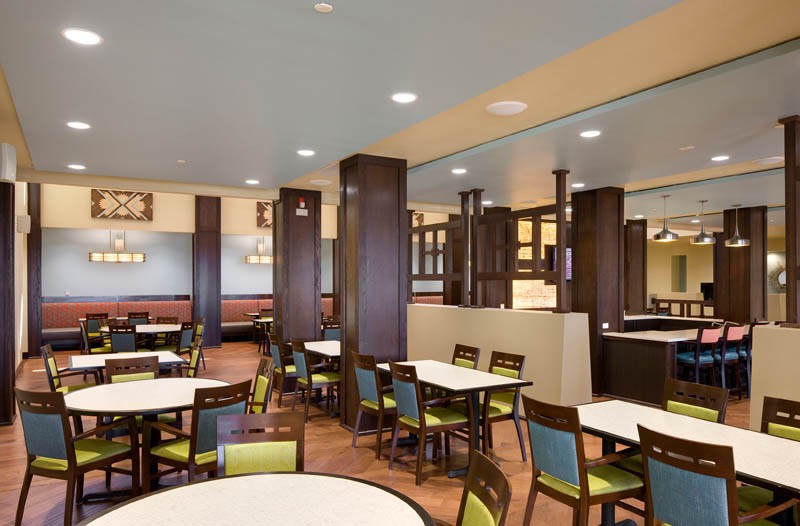 Spacious and modern dining area with neatly arranged tables and chairs.