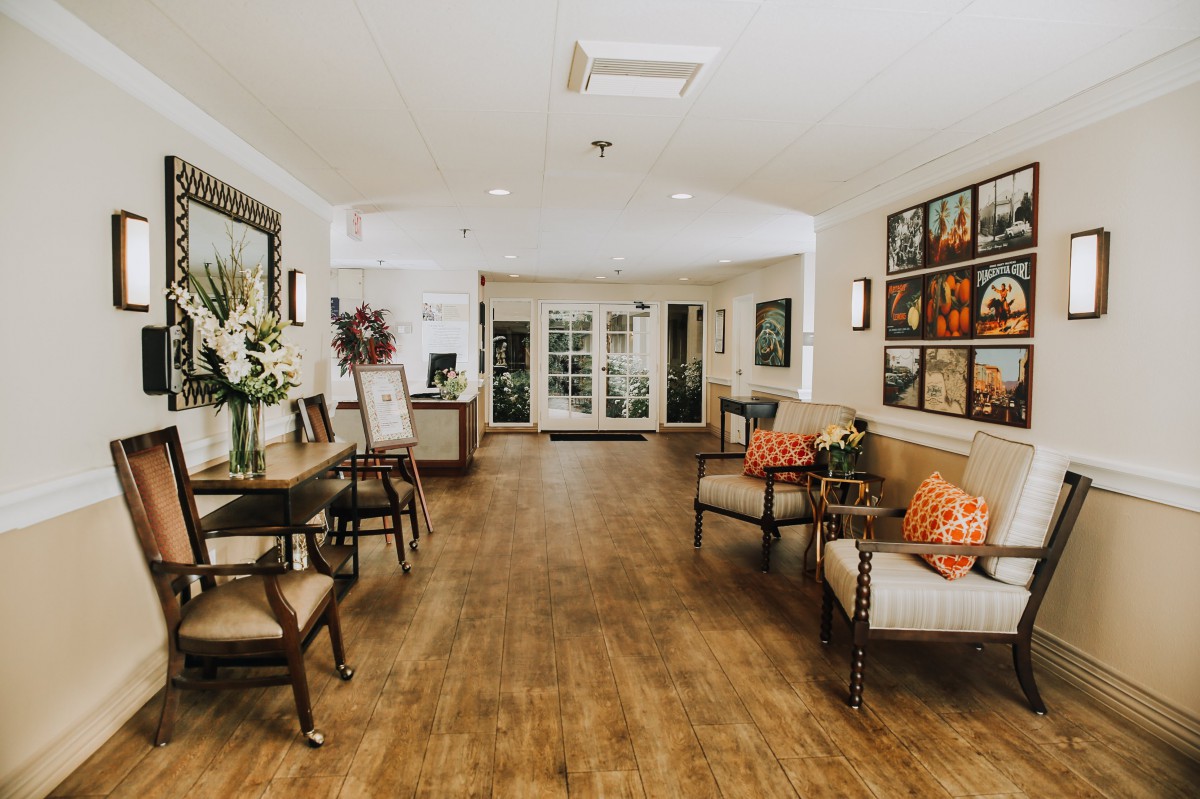 A welcoming lobby with comfortable seating, decorative flowers, and artwork adorning the walls.
