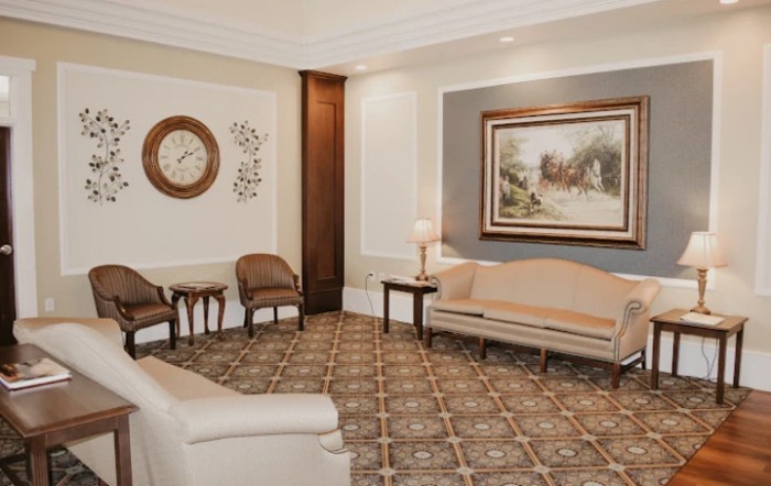 A cozy waiting room with elegant furniture and decor.