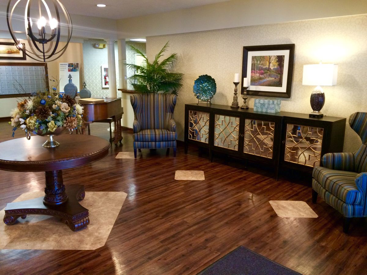 A stylish lobby area featuring elegant furniture, tasteful decor, and warm wood flooring.