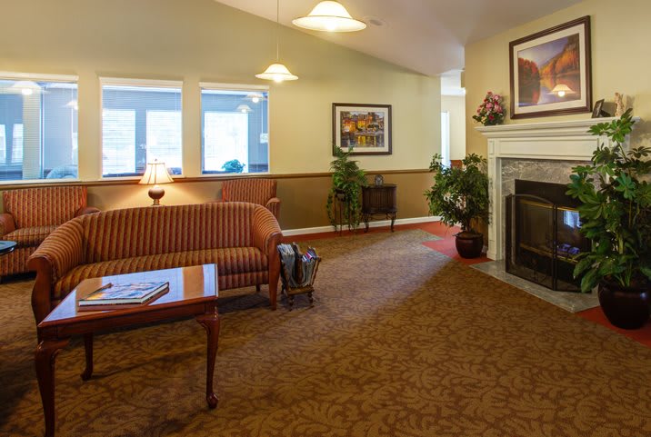 A cozy living room with a fireplace and comfortable seating.