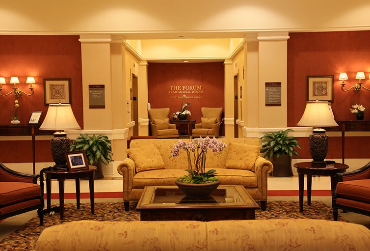 A warmly lit lobby with comfortable seating and elegant decor.