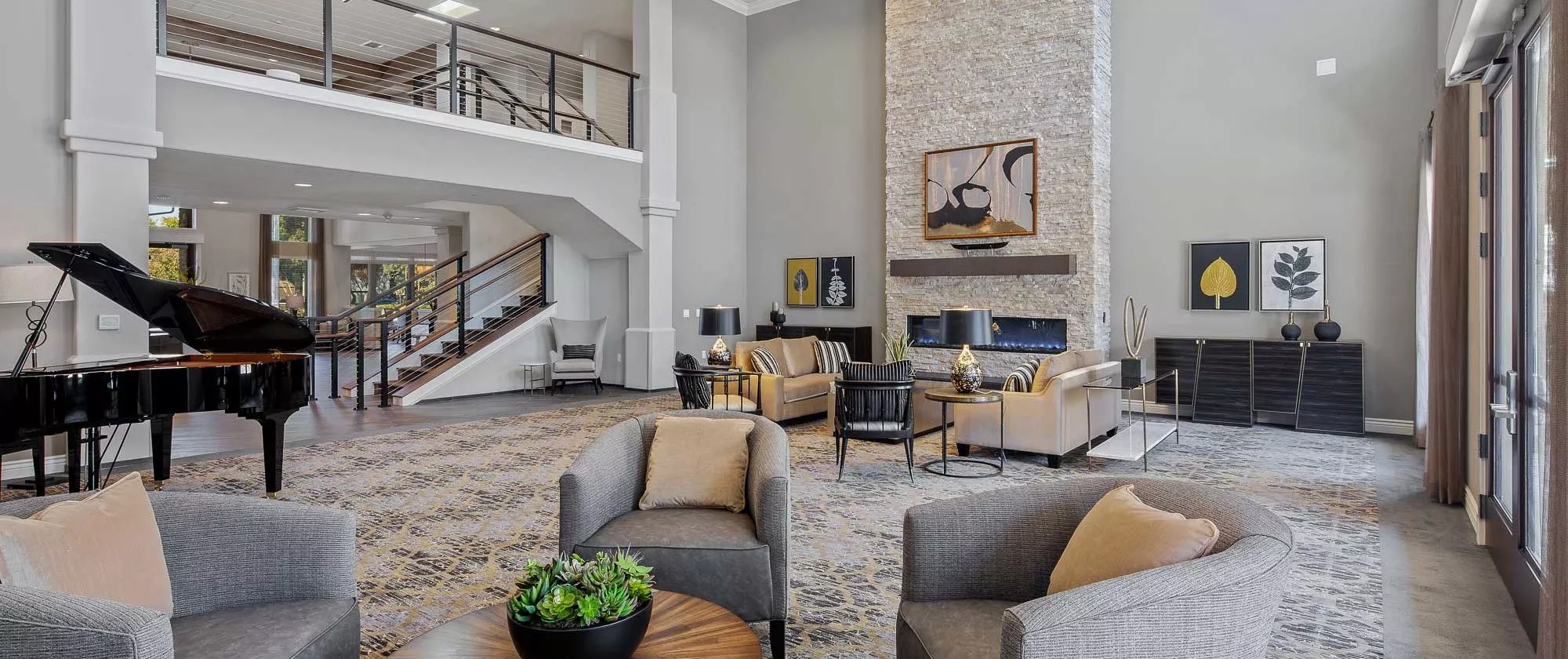 A modern living room featuring stylish furniture, a fireplace, and elegant decor.