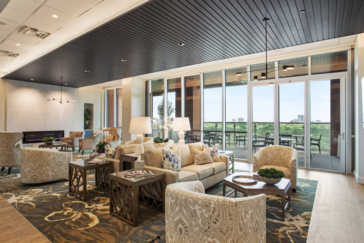 A modern living room with stylish furniture and large windows offering a scenic view.