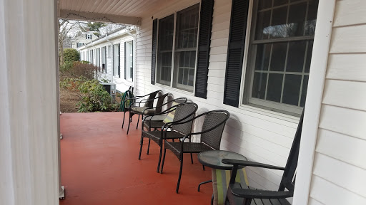A cozy porch featuring several chairs, perfect for enjoying a quiet moment outdoors.