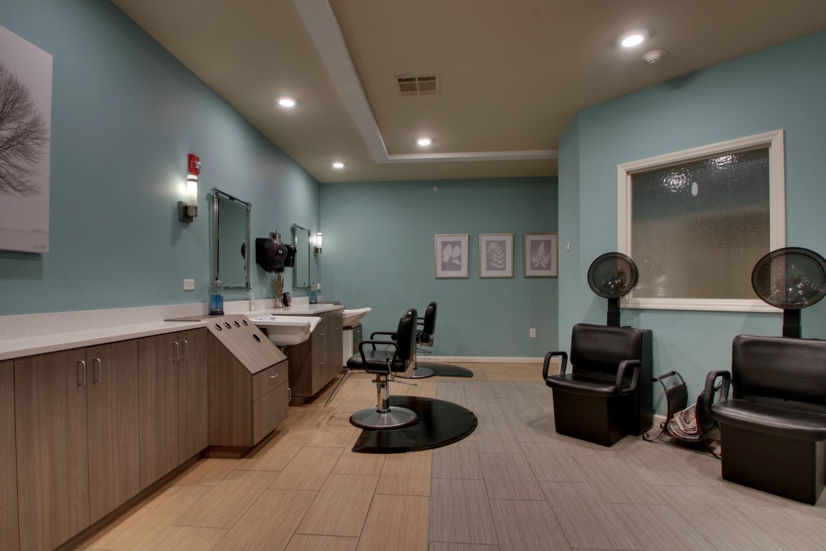 A modern salon with styling chairs, mirrors, and a hair dryer.