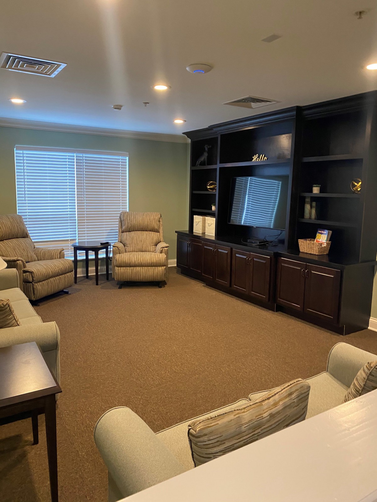A cozy living room with recliners and a large entertainment center.