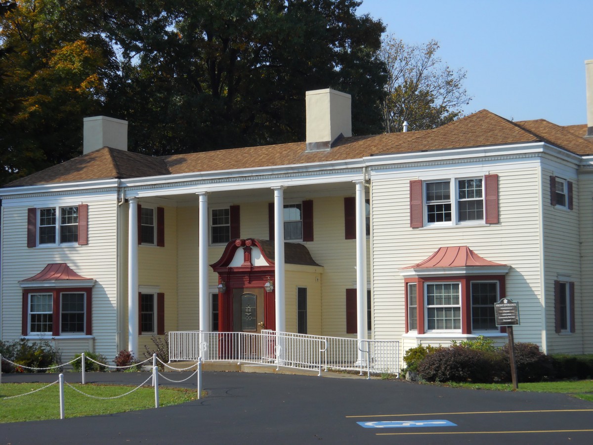 A colonial-style house with prominent white columns and a symmetrical facade.