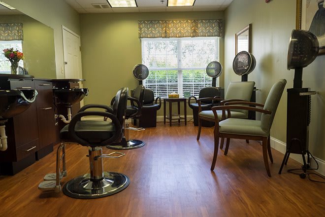 Interior of a salon with hair dryers and seating.
