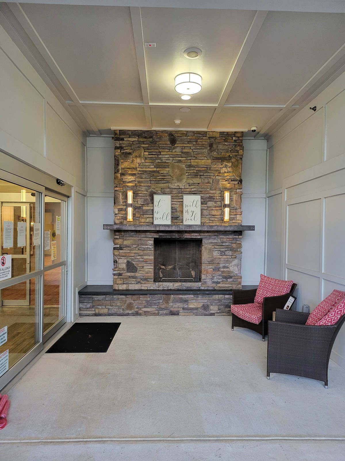 A welcoming lobby area featuring a stone fireplace and comfortable seating.