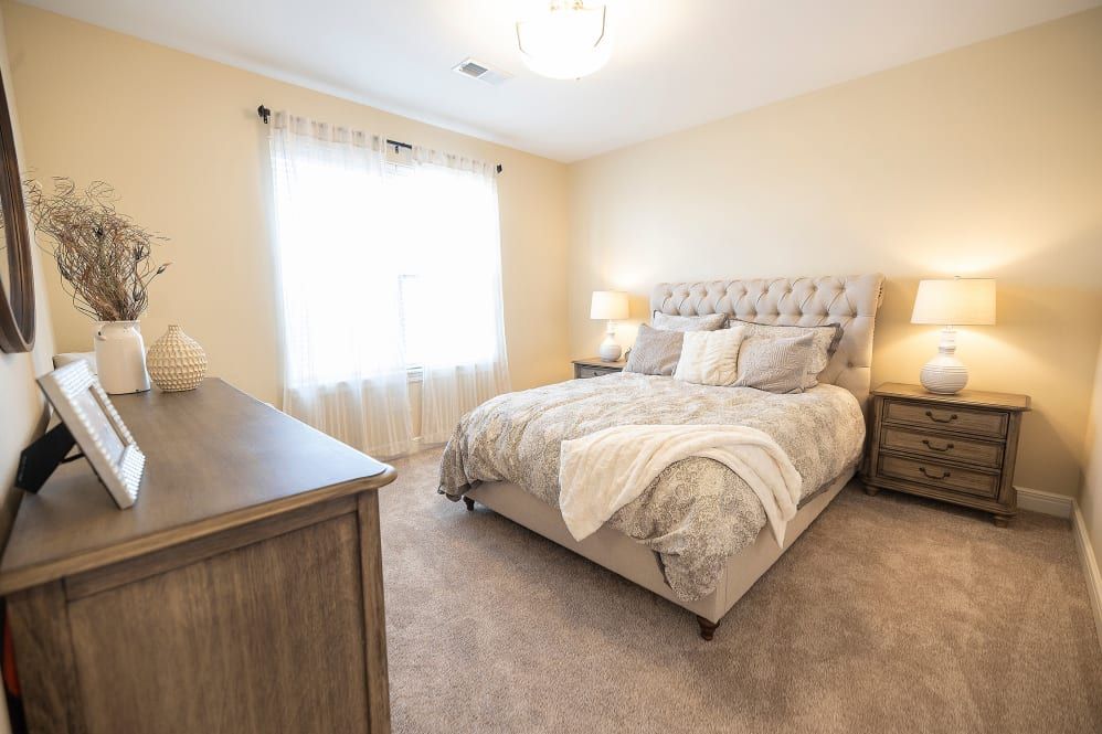 A cozy and elegantly decorated bedroom with soft lighting.