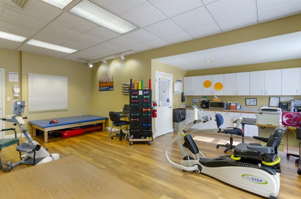 A clean and organized dental office with medical equipment and a treatment area.