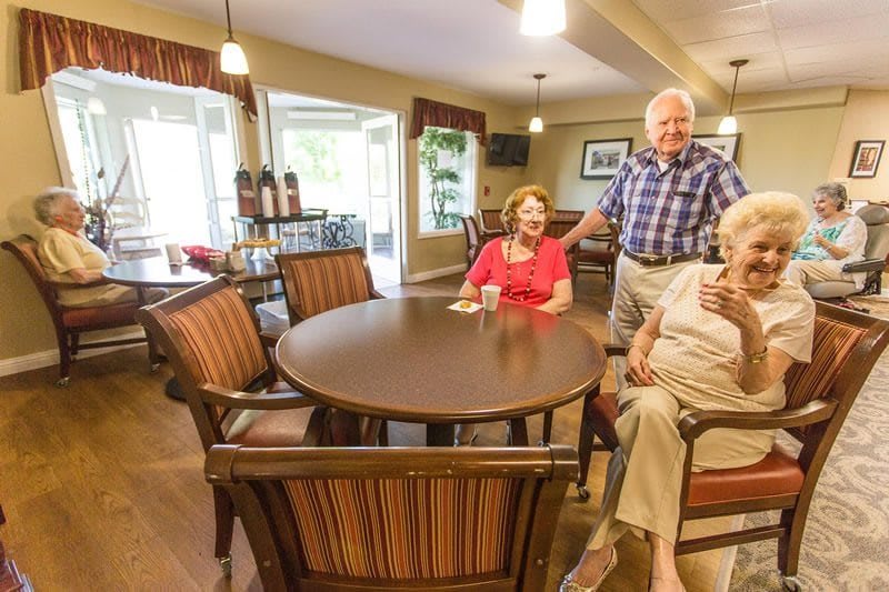 A group of seniors enjoying a social gathering in a cozy indoor setting.