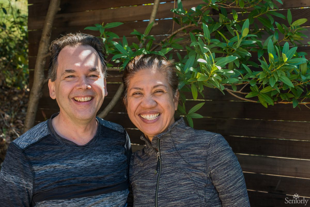 A smiling couple enjoying a sunny day outdoors.