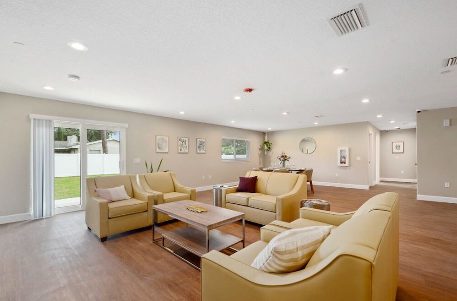 A spacious living room with modern furniture and warm lighting.