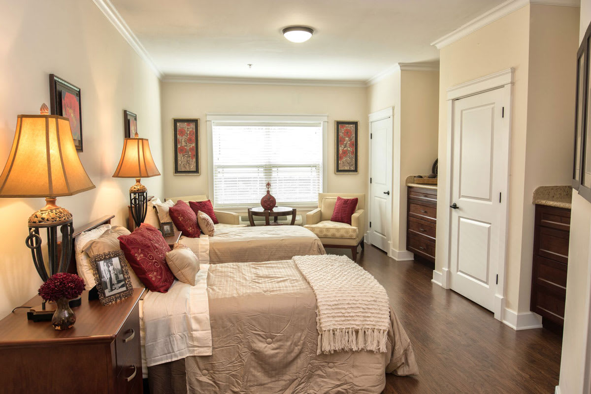 A cozy bedroom with twin beds, elegant decor, and a warm ambiance.