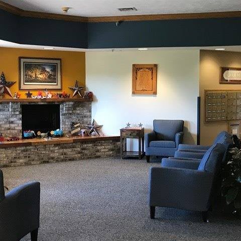 A cozy lobby with comfortable seating and a fireplace.