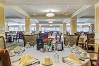 A spacious and elegantly decorated dining room with neatly set tables and chairs.