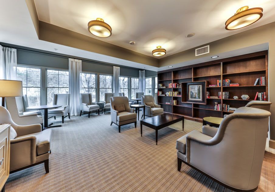 Cozy library lounge area with comfortable seating and ample natural light.